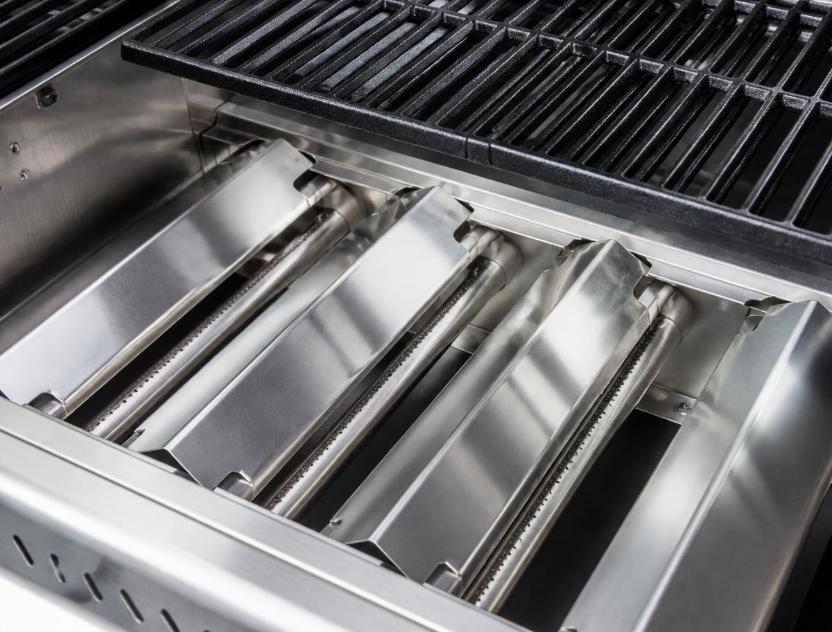 After restoration: clean Weber Genesis grill interior with new stainless flavorizer bars and clean cast iron grates